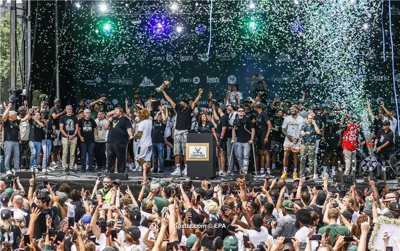 Milwaukee Bucks' Giannis Antetokounmpo holds up the NBA Championship trophy  and Finals MVP trophy to the crowd during a parade celebrating the  Milwaukee Bucks' NBA Championship basketball team Thursday, July 22, 2021